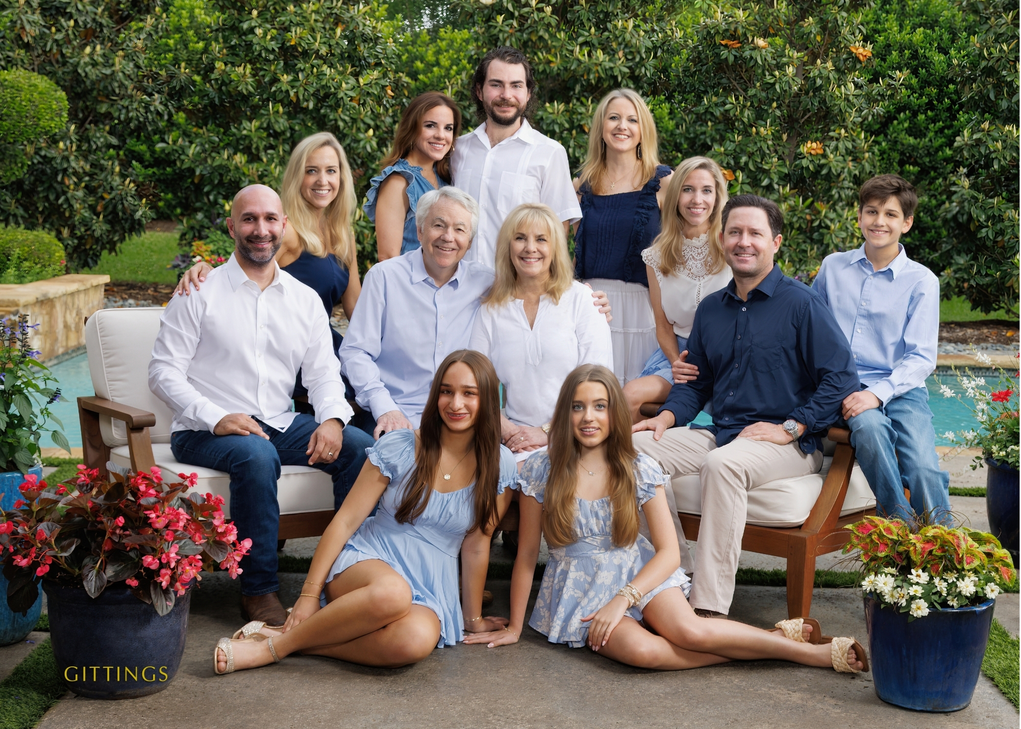 Large Family Portrait Outdoors With Coordinated Blue And White Outfits In A Cohesive Color Palette.
